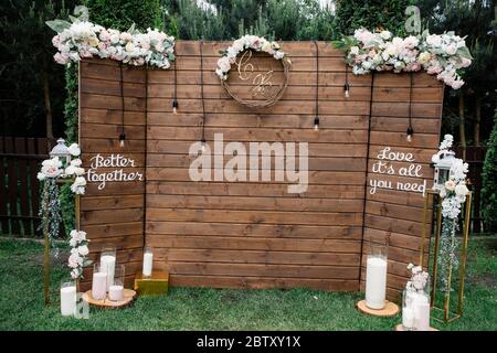 Wedding ceremony with a vintage candles. Arch for wedding area a is decorated with white flowers and greenery. Wedding day Stock Photo