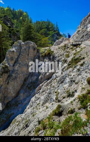 Young Man Walks On Rocky Hiking Trail In Ötschergräben In Austria Stock Photo