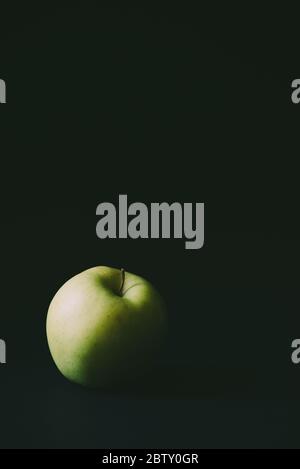 Single apple on black background Stock Photo