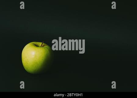 Single apple on black background Stock Photo