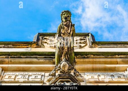 Prague, Czech Republic: Witch on broom gargoye statue on the Lesser Town Bridge Tower at the end of Charles Bridge Stock Photo