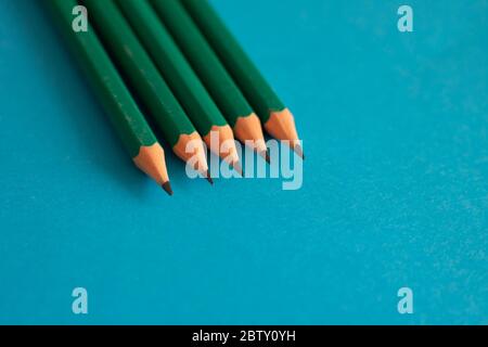 Photo with grey pencils on blue paper, view above. Office concept Stock Photo