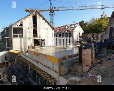 Workers are pouring new concrete layer in construction site Stock Photo