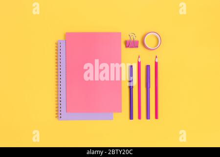 Set of colorful school supplies on a bright yellow background. Stationery creative layout. Stock Photo