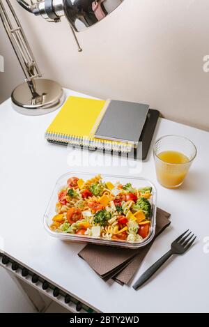Healthy food in lunch box, on working table with laptop Stock Photo