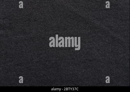 Black fabric material texture macro close up view. Surface of dark cotton Stock Photo