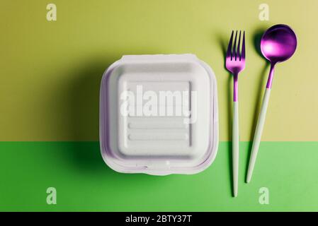 Healthy food concept: white burguer packaging closed with retro fork and spoon Stock Photo
