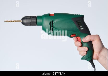 Man using drill side view isolated on white background Stock Photo