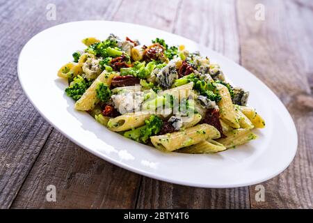 Penne with dried tomatoes and broccoli Stock Photo