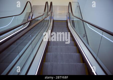 Moving escalator in the business center of a city . Modern escalator electronic system moving. Stock Photo
