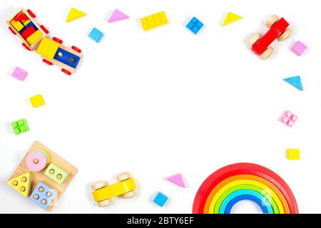 Wooden educational geometric stacking blocks toy, wooden train, car, rainbow, airplane and colorful blocks on white background Stock Photo