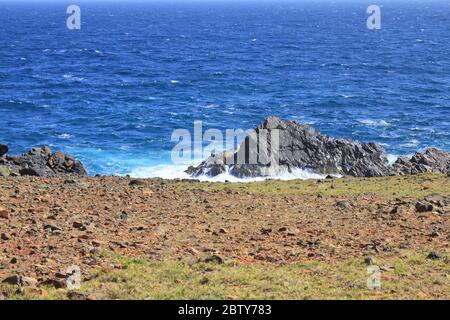 Volcanic rock coast and sea of Aruba island, Dutch Caribbean Stock Photo