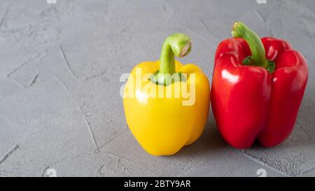 Bright vegetables Yellow and red bellpeppers Water drops on washed peppers. Light background Appetizing raw ripe peppers Stock Photo