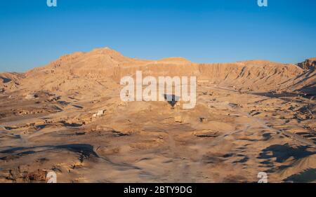 Silhouette shadow of a hot air balloon flying over the Temple of Hatshepsut on west bank of Luxor in Egypt Stock Photo