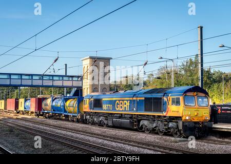 Class 66 locomotive in GB Railfreight livery hauling Bulkhall tanks in the UK. Stock Photo