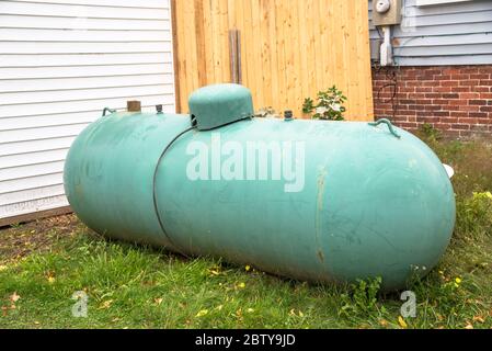 Old large propane tank in the backyard of a house Stock Photo