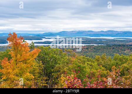 Magnificent forested mountain landscape dotted with lakes on an overcast autum day. Stunning fall foliage. Stock Photo