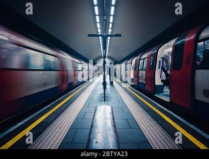 One stationary and one underground train in motion, London Tube Station, Clapham Common, Clapham, London, England, United Kingdom, Europe Stock Photo