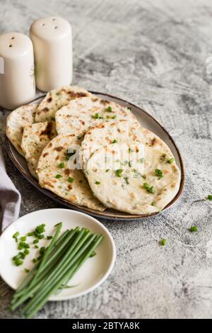 Onion naan - traditional indian bread. pita bread or scones with green onions Stock Photo