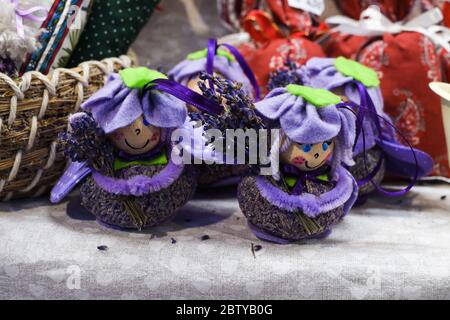 Group of delicate dried lavender bouquets with lila textile material, displayed for sale at an weekend deco fair for handmade artisans, selective focu Stock Photo