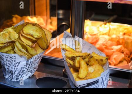 Fried swirl potato spiral during street food festival. Fast food. Stock Photo