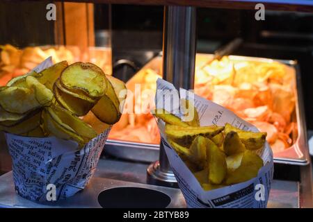 Fried swirl potato spiral during street food festival. Fast food. Stock Photo