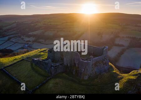 View by drone of sunrise over Carreg Cennen Castle in winter, Brecon Beacons National Park, Carmarthenshire, Wales, United Kingdom, Europe Stock Photo