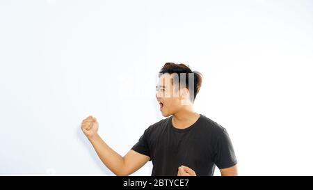 Cheerful Young Attractive Asian Man Celebrating Success Stock Photo