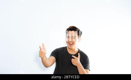 advertisement concept. Man dressed in black pointing with finger copy space empty blank isolated on white Stock Photo