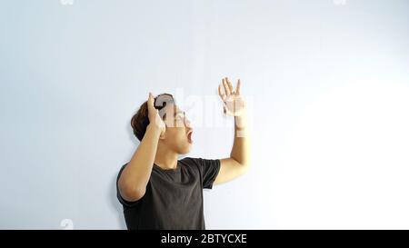 Shocked and wow gasture of Asian man on white space in black t-shirt. Stock Photo