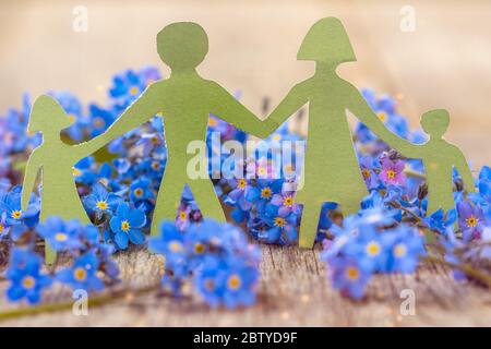 Paper cut of family with flowers background.Family Life Insurance.Protecting family, family concepts. Stock Photo