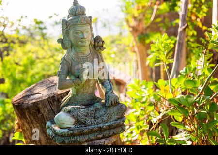 Traditional stone sculpture of hindu god. Outside asian style interior. Interior detail from a luxury hotel resort. Bali, Indonesia Stock Photo