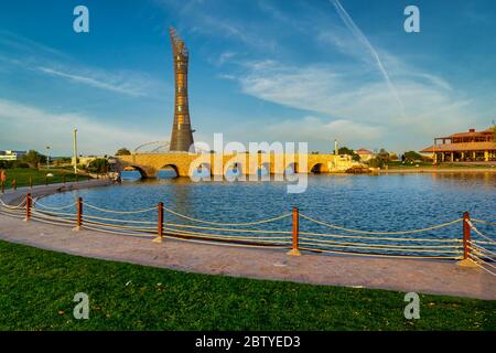 Aspire park Doha, Qatar daylight view with lake and bridge in Foreground and  The Torch Doha Hotel in background Stock Photo