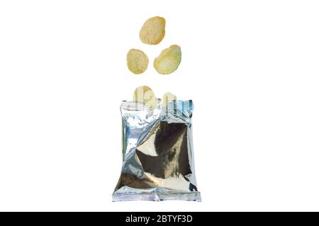 potato chip falling to aluminium foil packaging on white background Stock Photo