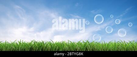 many soap bubbles landing on the green lawn with a cloudy blue panoramic sky background  Stock Photo