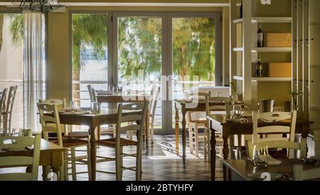 Empty dining room in the Marbella Beach Hotel, Corfu, Greece. Stock Photo