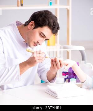 The hands during manicure care session Stock Photo