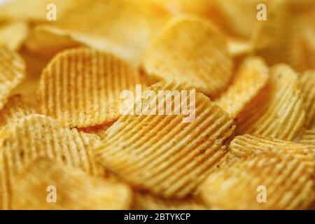 Corrugated Potato Chips. Food background. Top view. Stock Photo