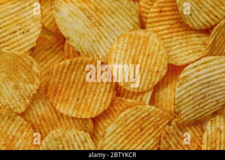 Corrugated Potato Chips. Food background. Top view. Stock Photo