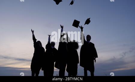Silhouette of Diverse International Students Celebrating Graduat Stock Photo