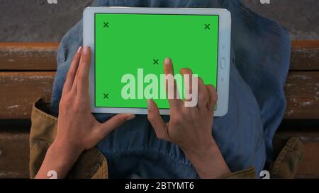 Woman's hands working on a tablet pc. Stock Photo