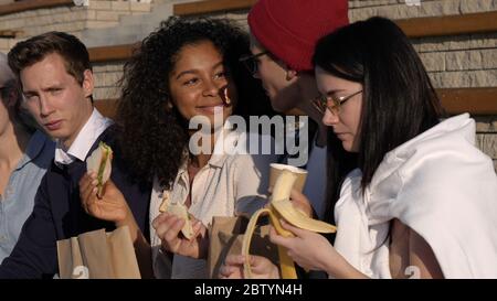 Friends students eating and having fun. Stock Photo