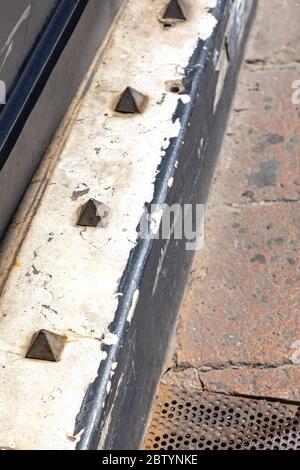 Metal Spikes Anti Homeless Device in Front of Building Stock Photo - Alamy