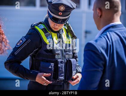 28 May 2020, Mecklenburg-Western Pomerania, Schwerin: Superintendent Katrin Hilberling is wearing one of the new overt vests for equipment which was officially presented by the Mecklenburg-Vorpommern state police. The so-called 'outer carrying case' is a vest that provides additional protection for the police officers and makes it easier to store equipment. Police officers have contributed to the development of the new model with their practical experience. Photo: Jens Büttner/dpa-Zentralbild/dpa Stock Photo