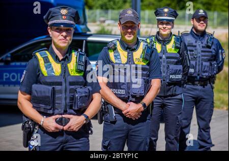28 May 2020, Mecklenburg-Western Pomerania, Schwerin: Police officers wear the new overt vests for equipment, which were officially presented by the Mecklenburg-Vorpommern state police, at a photo session. The so-called 'outer carrying case' is a vest that provides additional protection for police officers and makes it easier to store equipment. Police officers have contributed to the development of the new model with their practical experience. Photo: Jens Büttner/dpa-Zentralbild/dpa Stock Photo