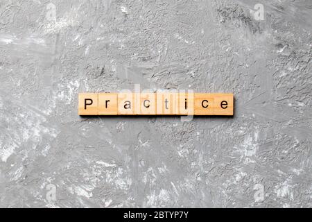 practice word written on wood block. practice text on table, concept. Stock Photo