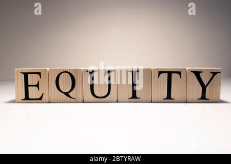 Equity Word Written In Wooden Cube. Close up.