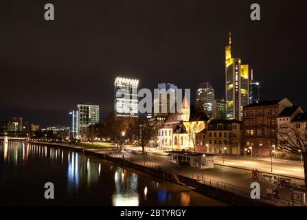 Frankfurt am Main, Germany, Febr 15 2020:  Night view of Frankfurt from the bridge over the Main River in winter. Contrast between historic buildings Stock Photo