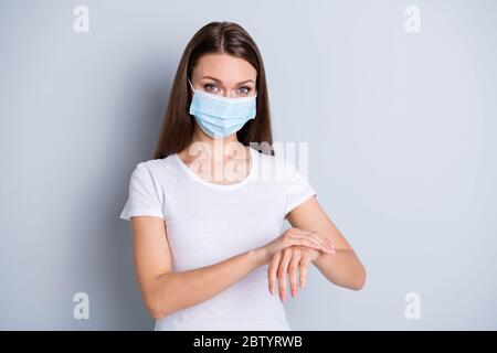 Photo of beautiful lady social distancing contacting smearing hands antiseptic disinfection gel sensitive skin after latex gloves wear protect face Stock Photo