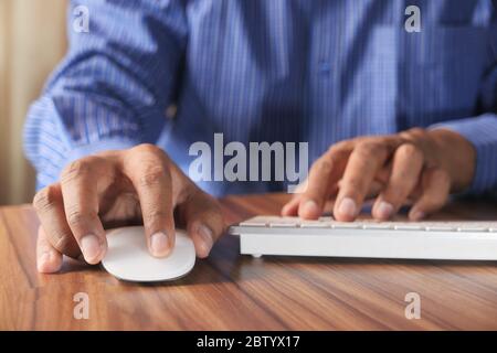Businessman hand with computer mouse, Close up Stock Photo